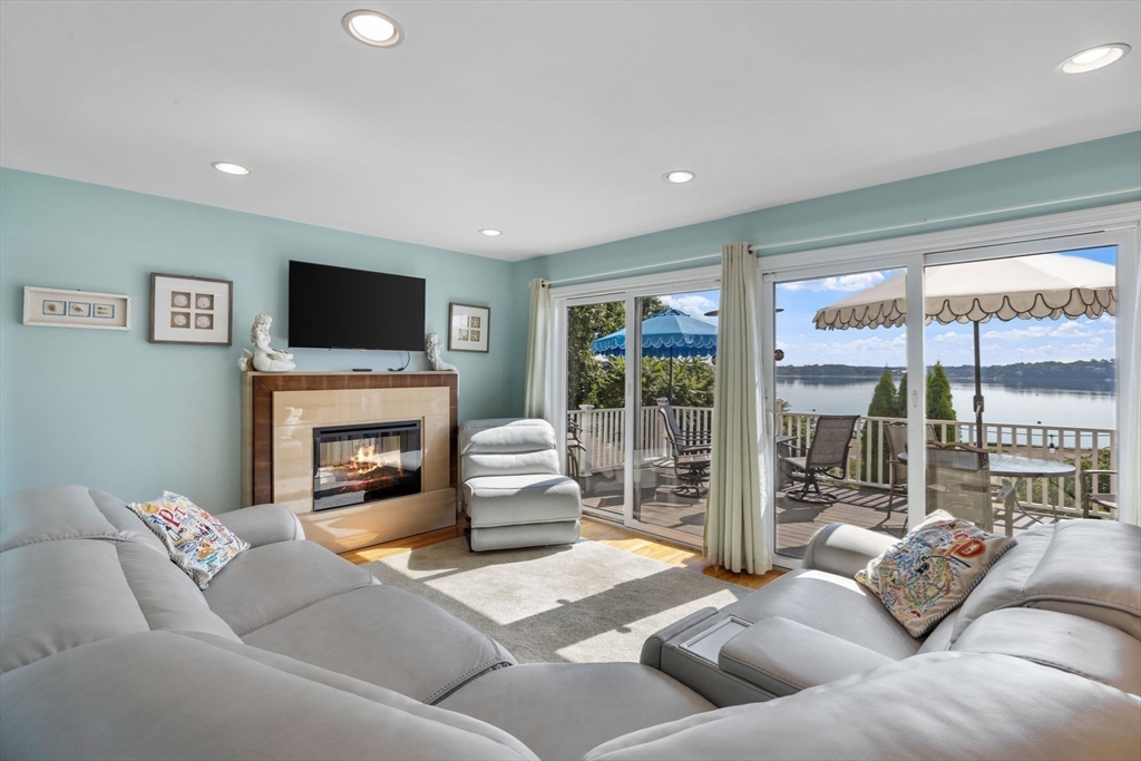 2 Wychunas Avenue Wareham, MA 02532 - Photo 13 of 37 a living room with furniture a fireplace and a flat screen tv