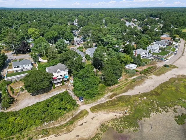 an aerial view of a house with a yard and lake view