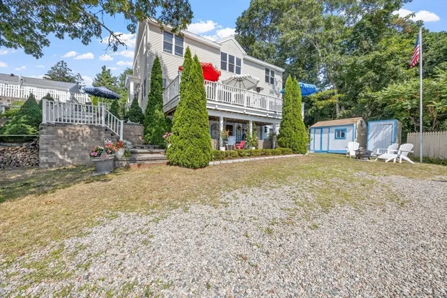 a view of a house with a yard and pathway