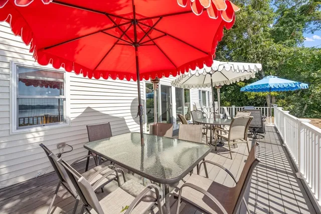 a patio with a table and chairs under an umbrella