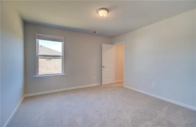 an empty room with a empty space and windows