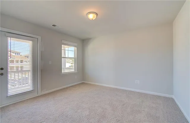 a view of a balcony with wooden floor and fence