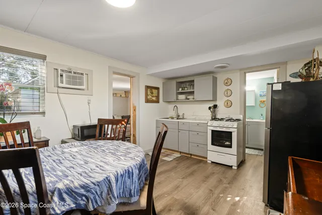 a large white kitchen with sink stove and refrigerator