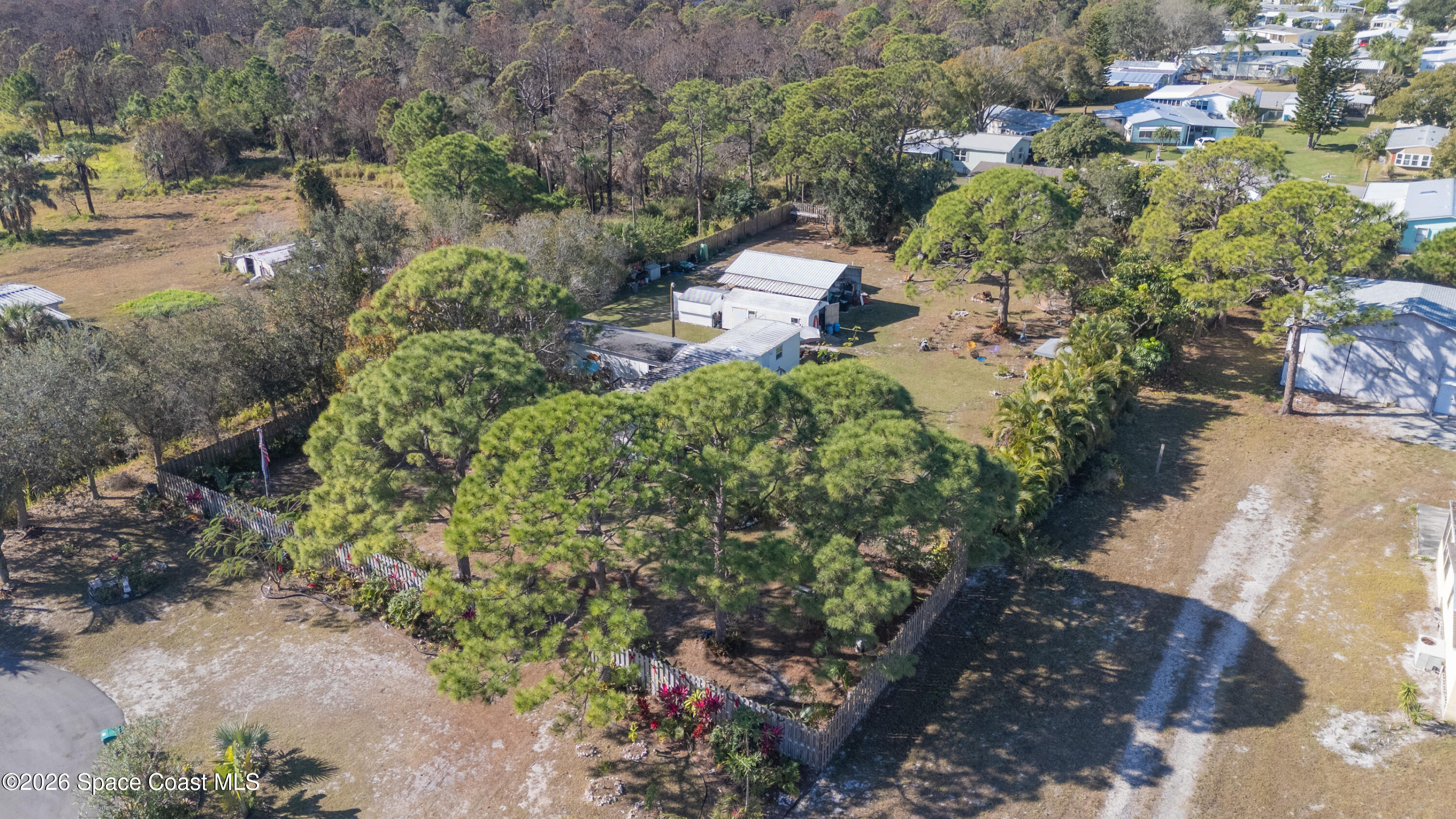 8280 Pine Ridge Trail Sebastian, FL 32976 - Photo 26 of 43 an aerial view of a house with a yard and trees