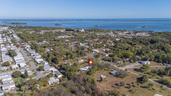 an aerial view of a house with a yard