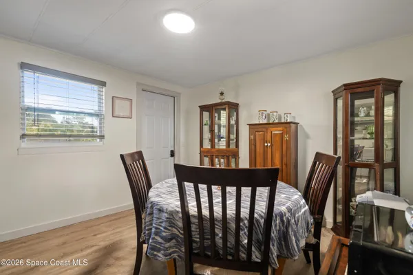 a view of a dining room with furniture window and wooden floor