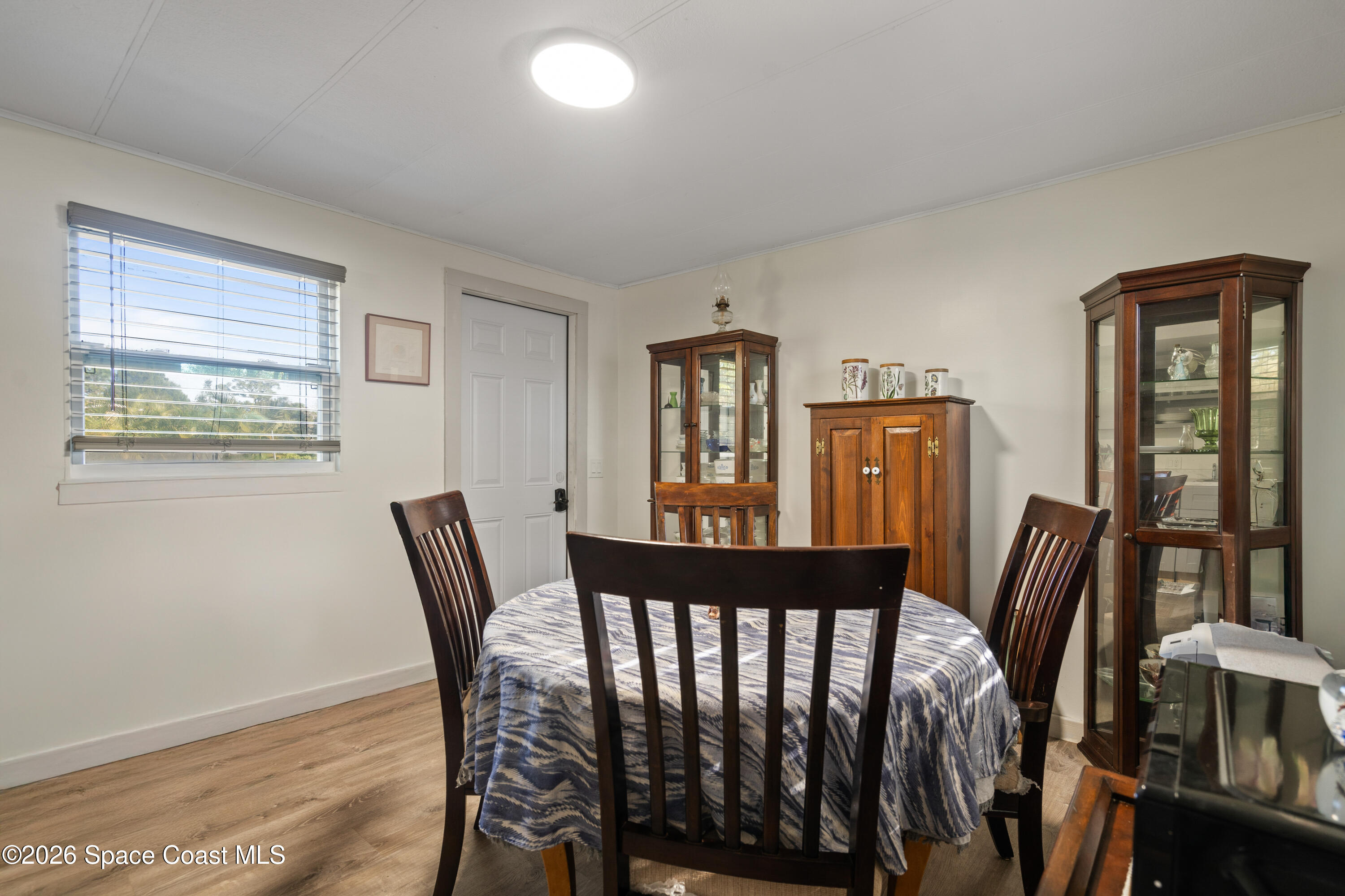 8280 Pine Ridge Trail Sebastian, FL 32976 - Photo 4 of 43 a view of a dining room with furniture window and wooden floor