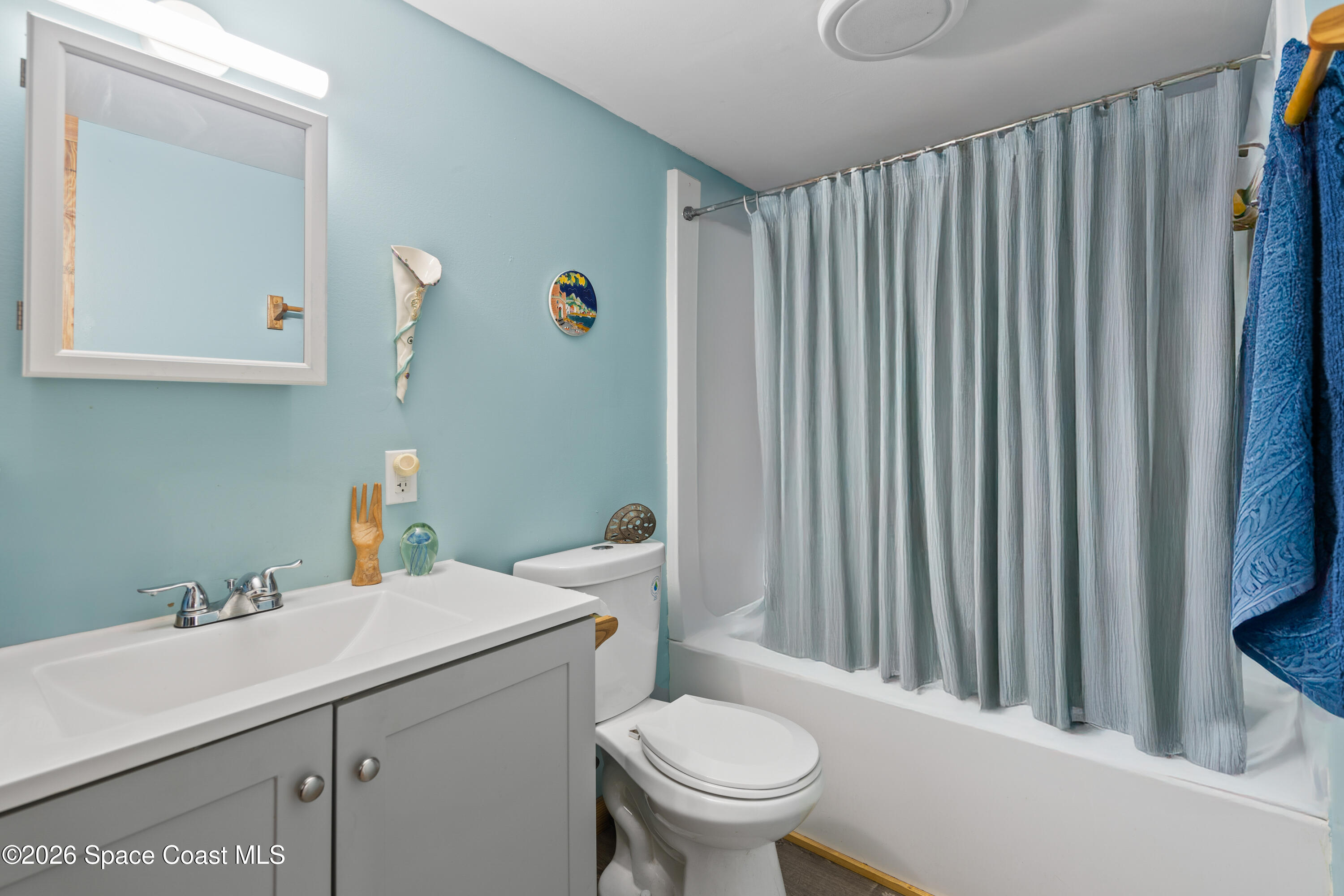 8280 Pine Ridge Trail Sebastian, FL 32976 - Photo 6 of 43 a bathroom with a sink a toilet and vanity