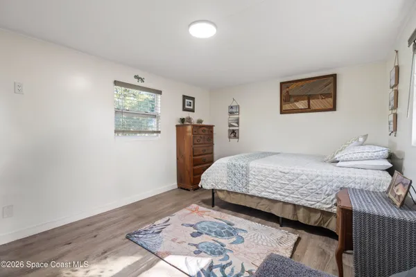 a bedroom with a large bed and a window