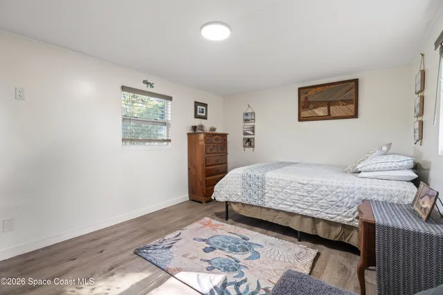 a bedroom with a large bed and a window