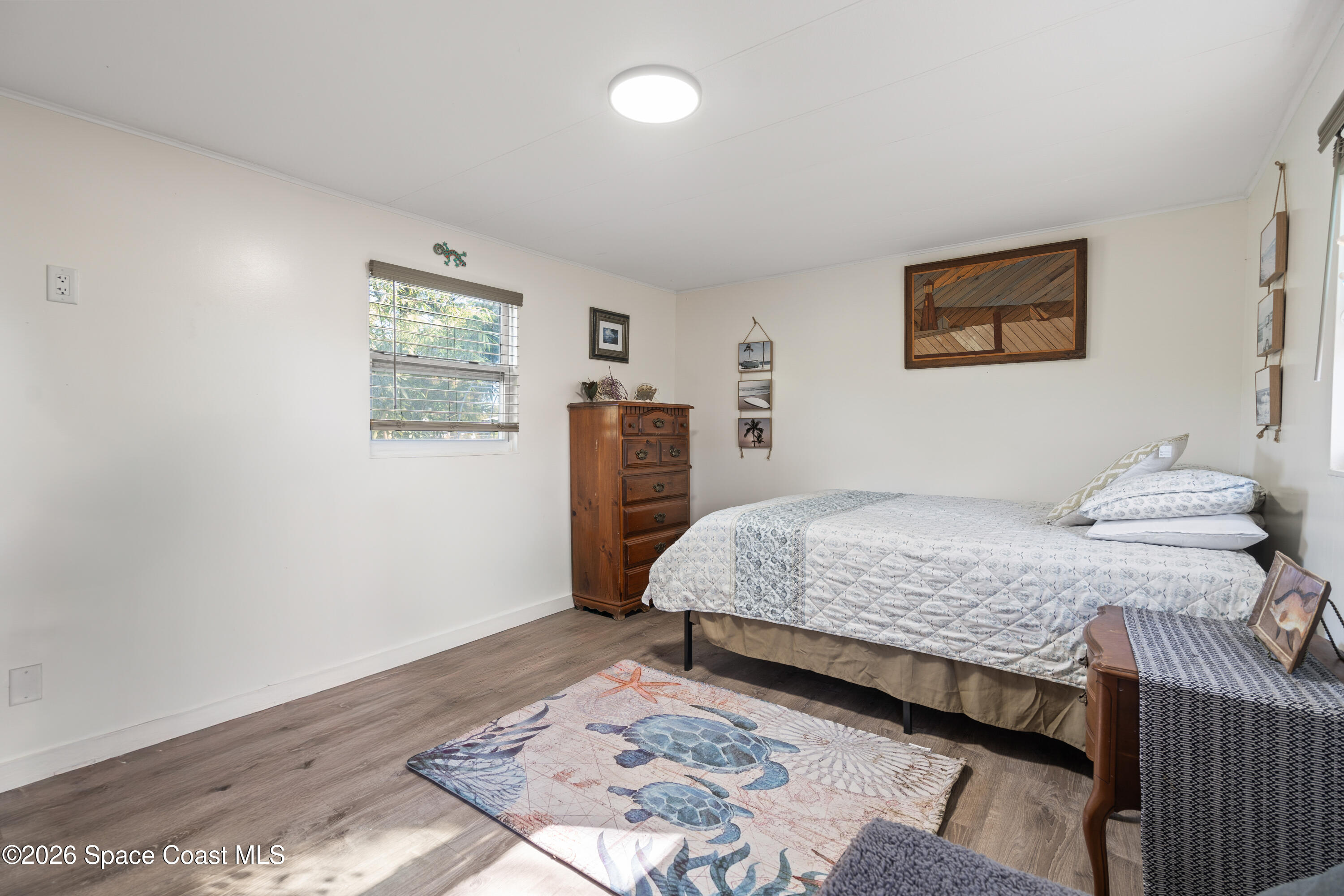 8280 Pine Ridge Trail Sebastian, FL 32976 - Photo 7 of 43 a bedroom with a large bed and a window