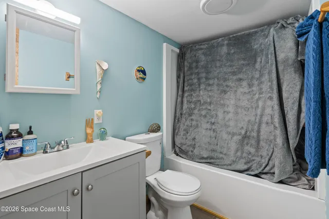 a bathroom with a sink a toilet and a shower