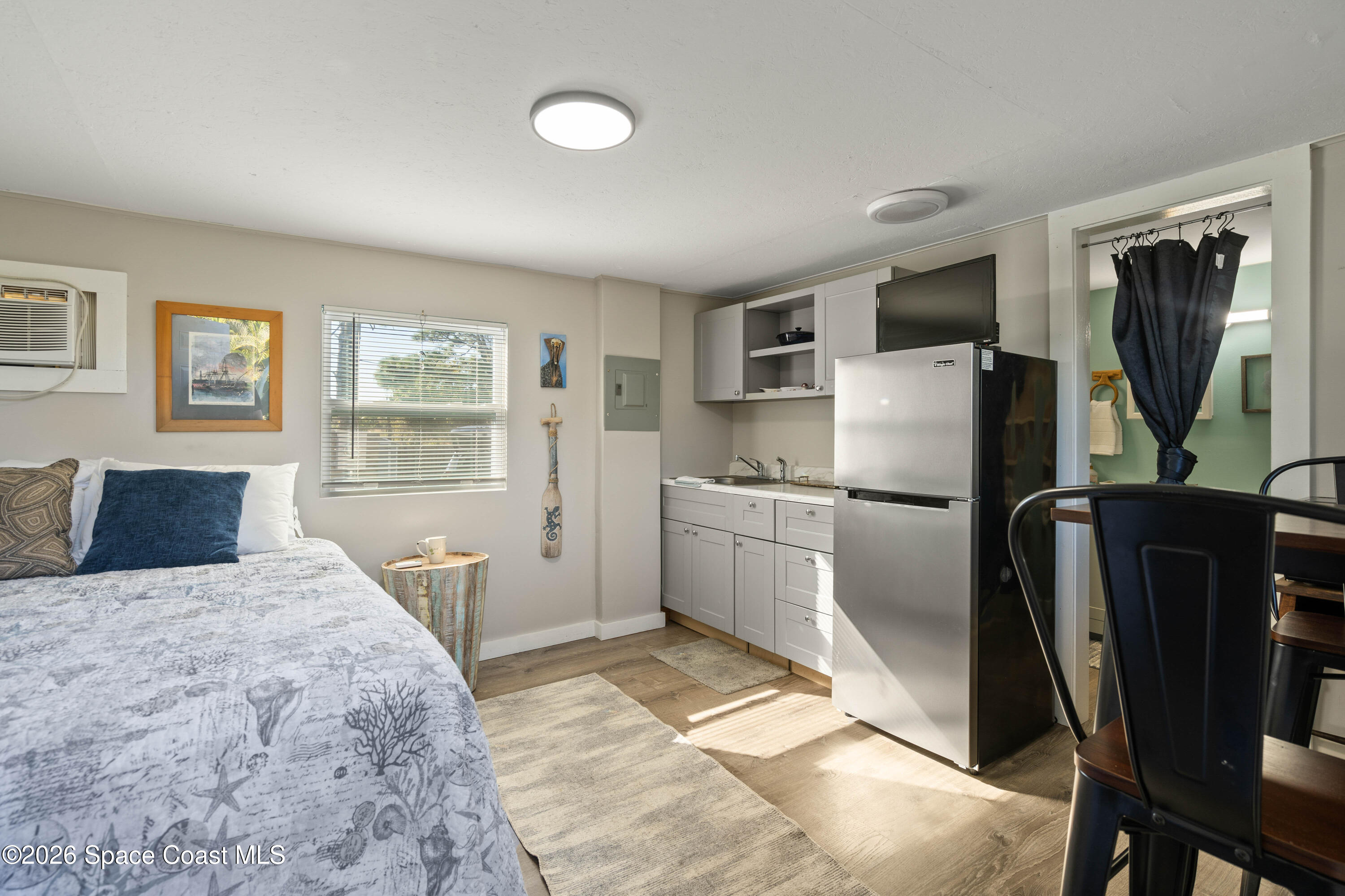 8280 Pine Ridge Trail Sebastian, FL 32976 - Photo 10 of 43 a bedroom with a bed a mirror and a window