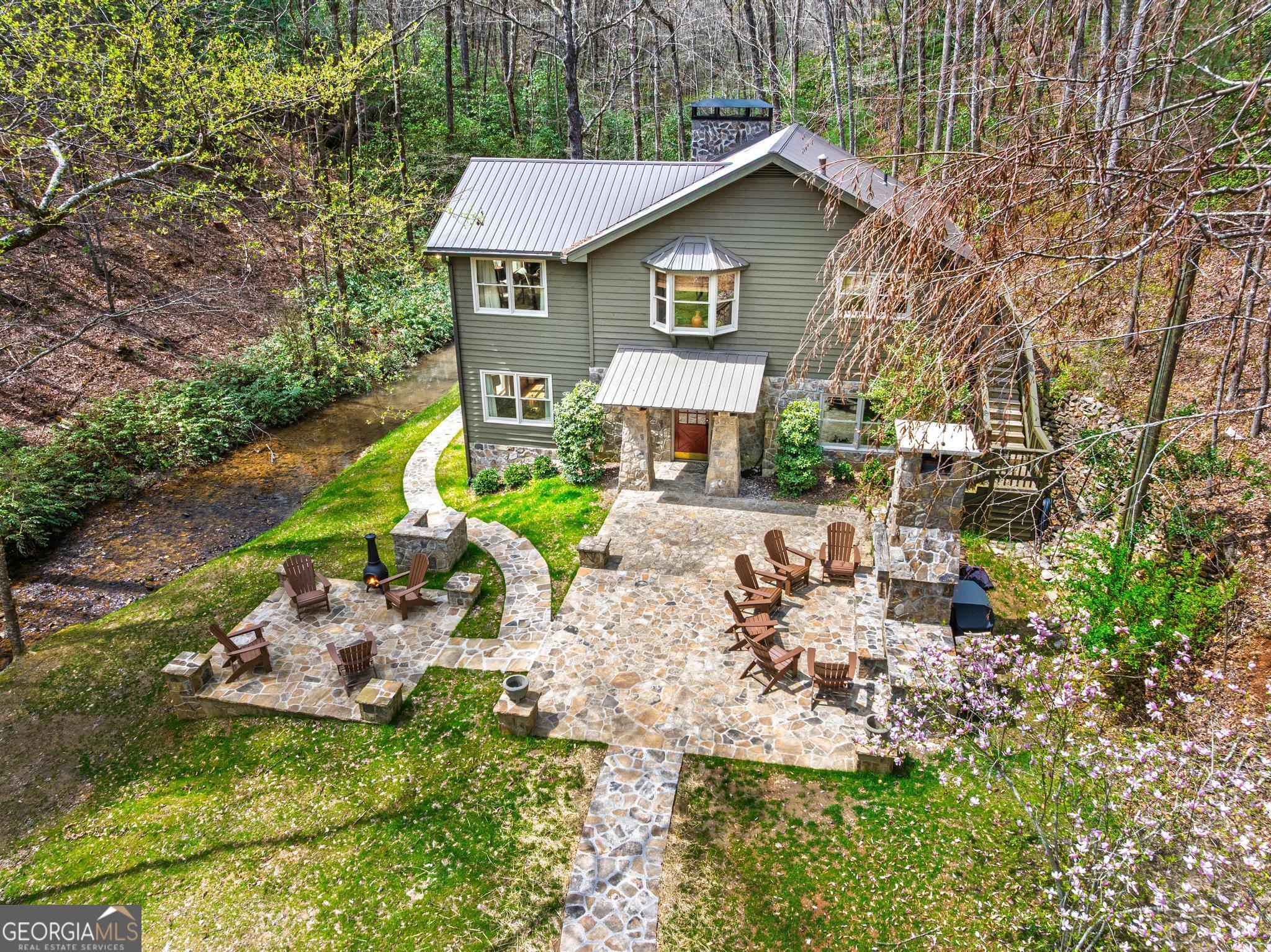 310 Blue Ridge Drive Sautee Nacoochee, GA 30571 - Photo 49 of 78 a view of a yard with plants and a bench