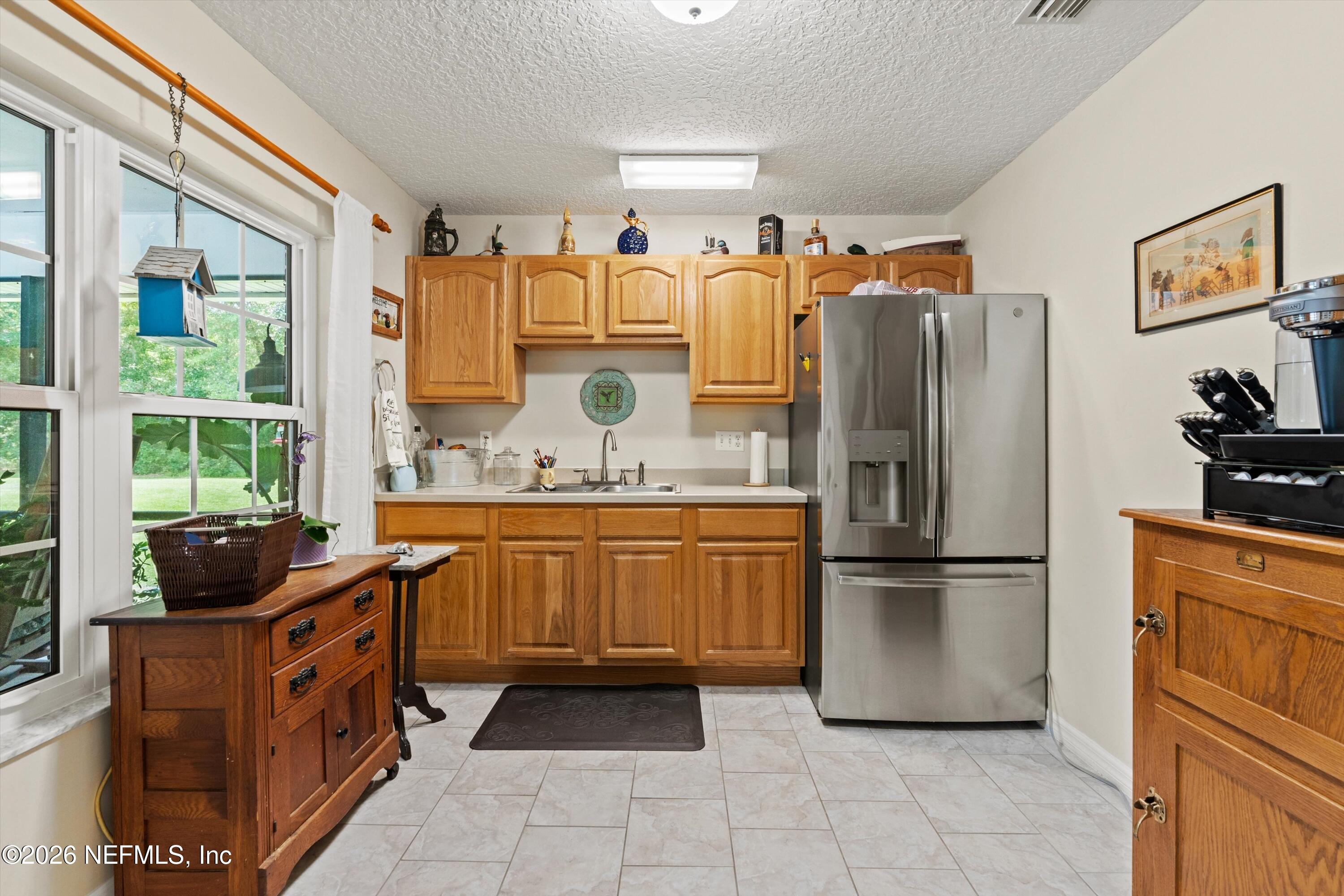 5566 Don Manuel Road Elkton, FL 32033 - Photo 31 of 47 a kitchen with stainless steel appliances granite countertop a refrigerator and a stove