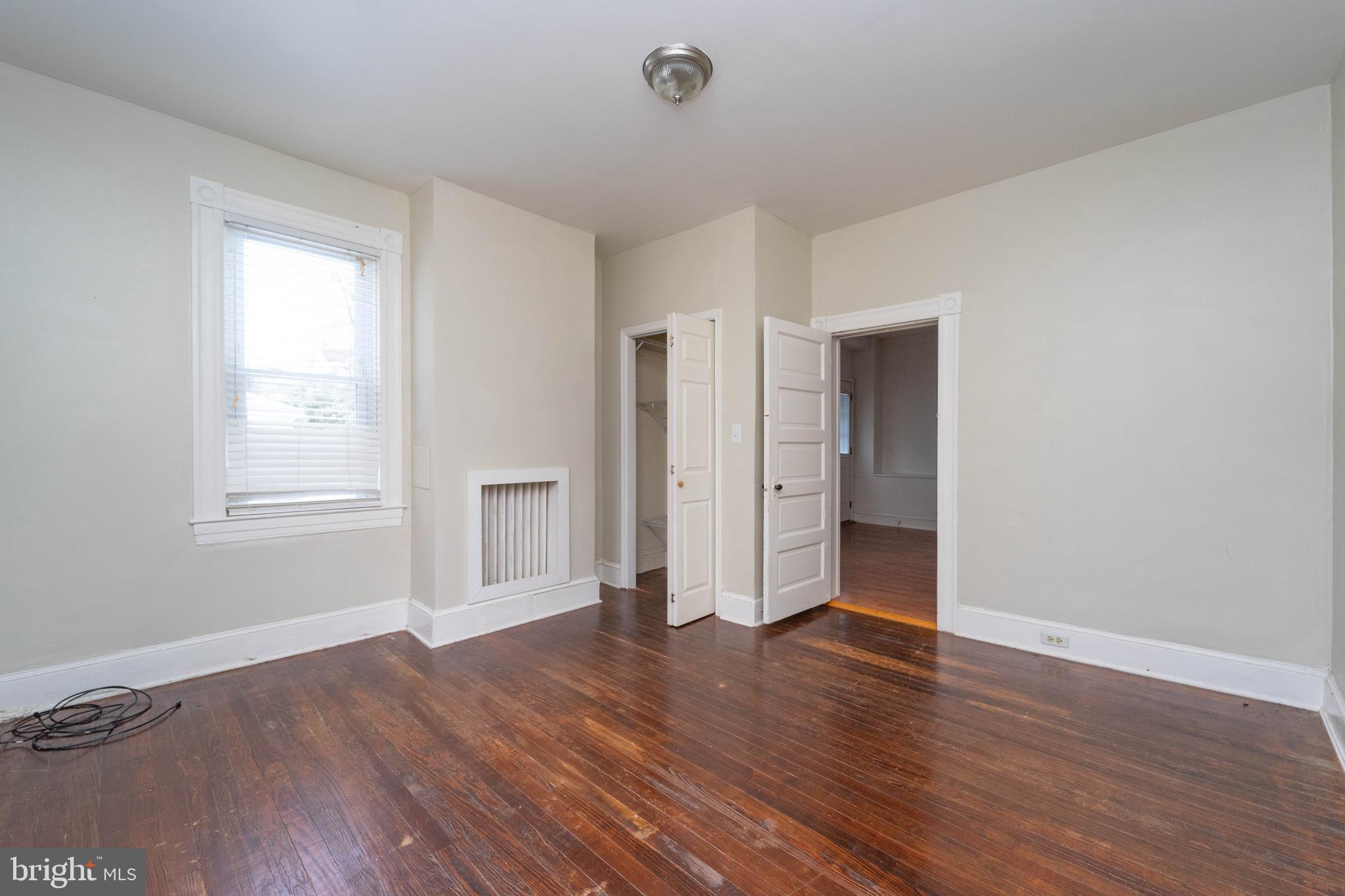 3204 Batavia Avenue Baltimore, MD 21214 - Photo 13 of 31 a view of an empty room with wooden floor and a window