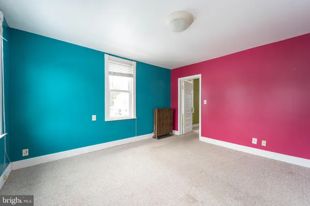 a view of an empty room with a fireplace