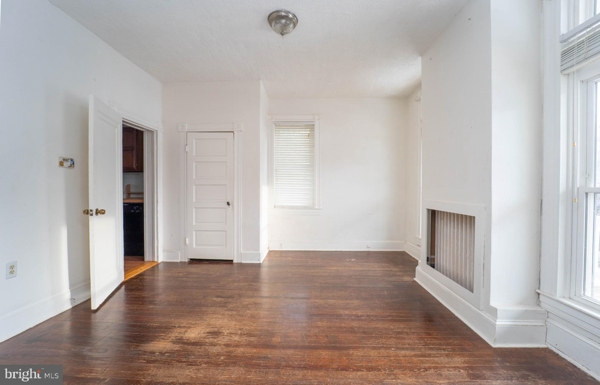 3204 Batavia Avenue Baltimore, MD 21214 - Photo 4 of 31 an empty room with wooden floor and windows