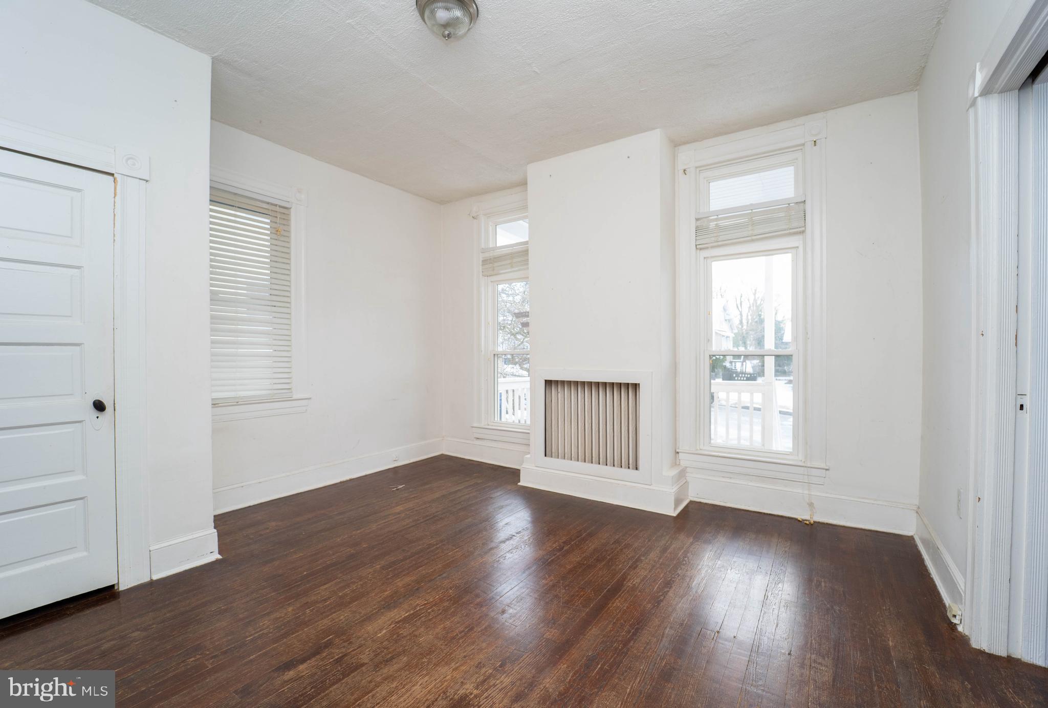 3204 Batavia Avenue Baltimore, MD 21214 - Photo 5 of 31 an empty room with wooden floor and windows