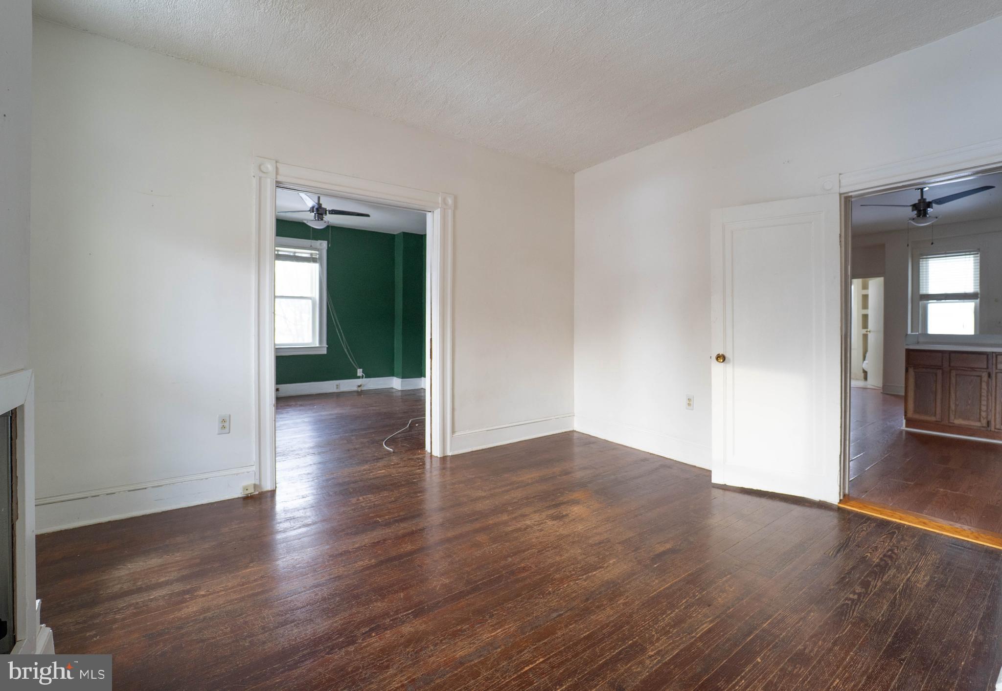 3204 Batavia Avenue Baltimore, MD 21214 - Photo 6 of 31 an empty room with wooden floor & windows