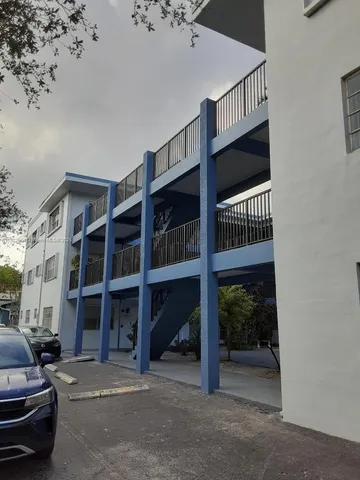 a view of a car park in front of house