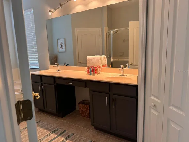 a bathroom with a sink double vanity and a mirror