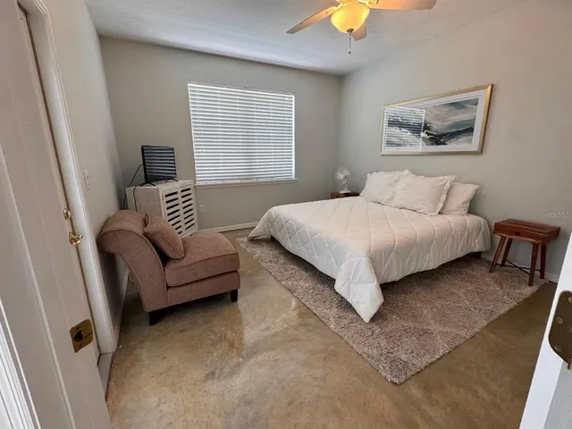 a bedroom with a bed and a couch