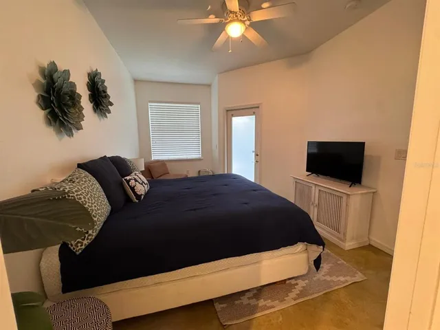 a bedroom with a bed and a television