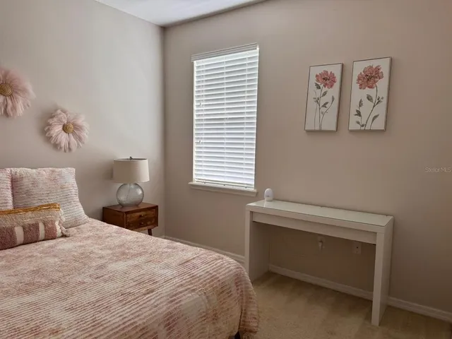 a bedroom with a bed and a window