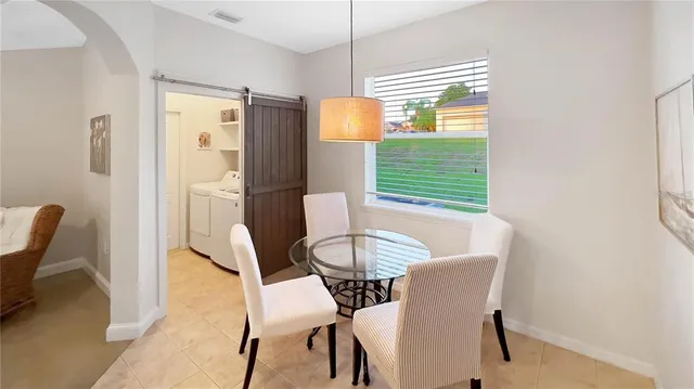 a view of a dining room with furniture and a window