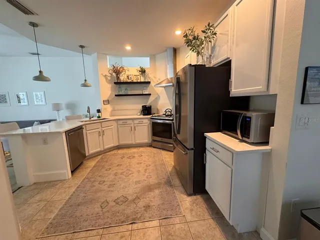 a kitchen with a sink appliances and cabinets