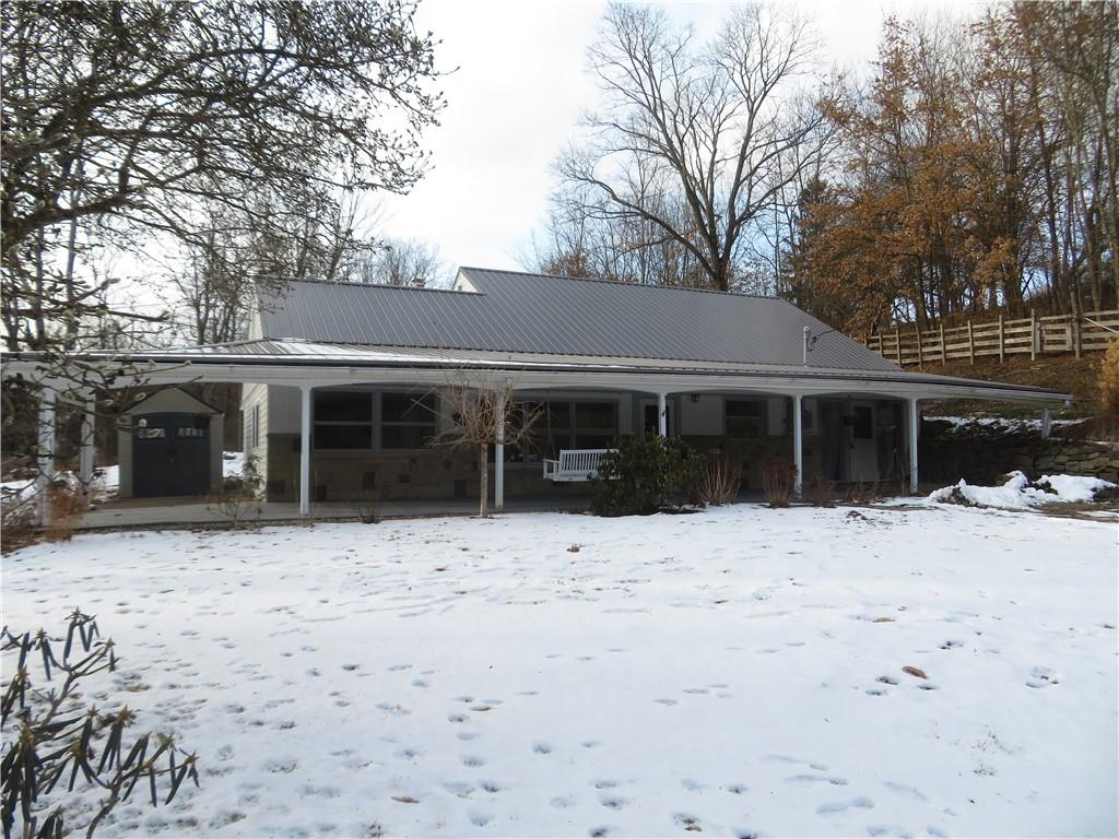 a front view of a house with a yard covered in snow