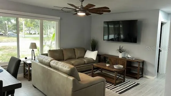 a living room with furniture and a flat screen tv