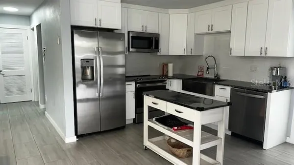 a kitchen with stainless steel appliances and wooden cabinets