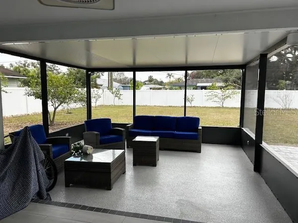 a living room with furniture and a floor to ceiling window