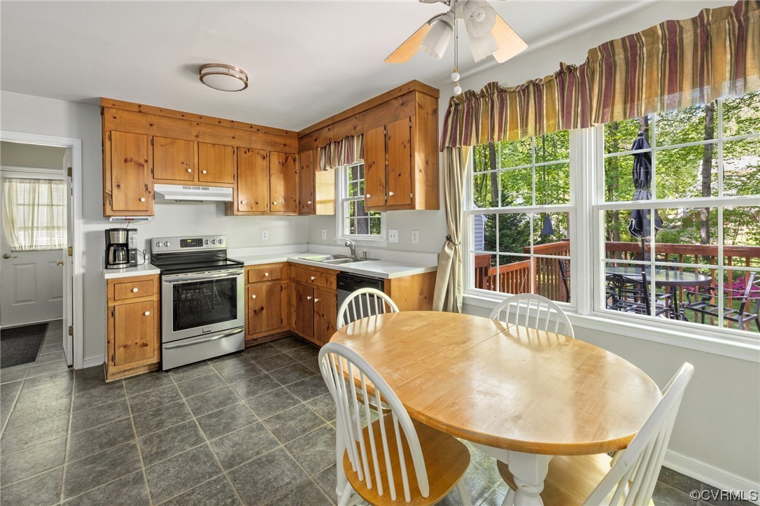 13637 Decidedly Court Midlothian, VA 23112 - Photo 13 of 25 a kitchen with a stove a sink a kitchen island a dining table and chairs