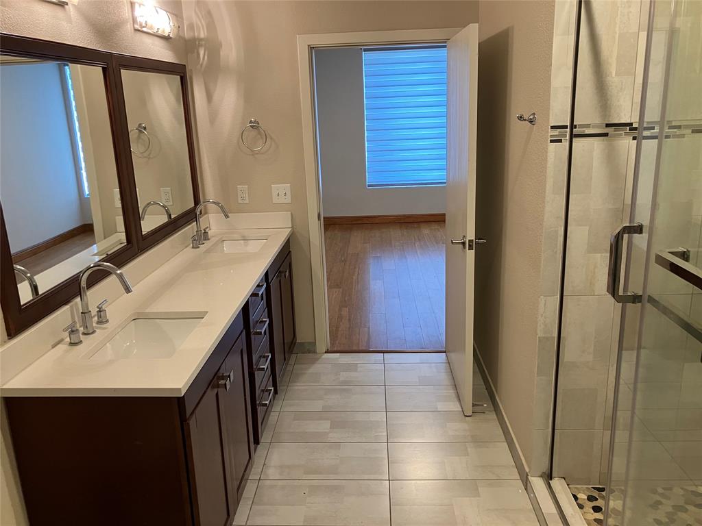 1220 West Trinity Mills Road, Unit 5009 Carrollton, TX 75006 - Photo 10 of 25 a bathroom with a sink vanity and a mirror