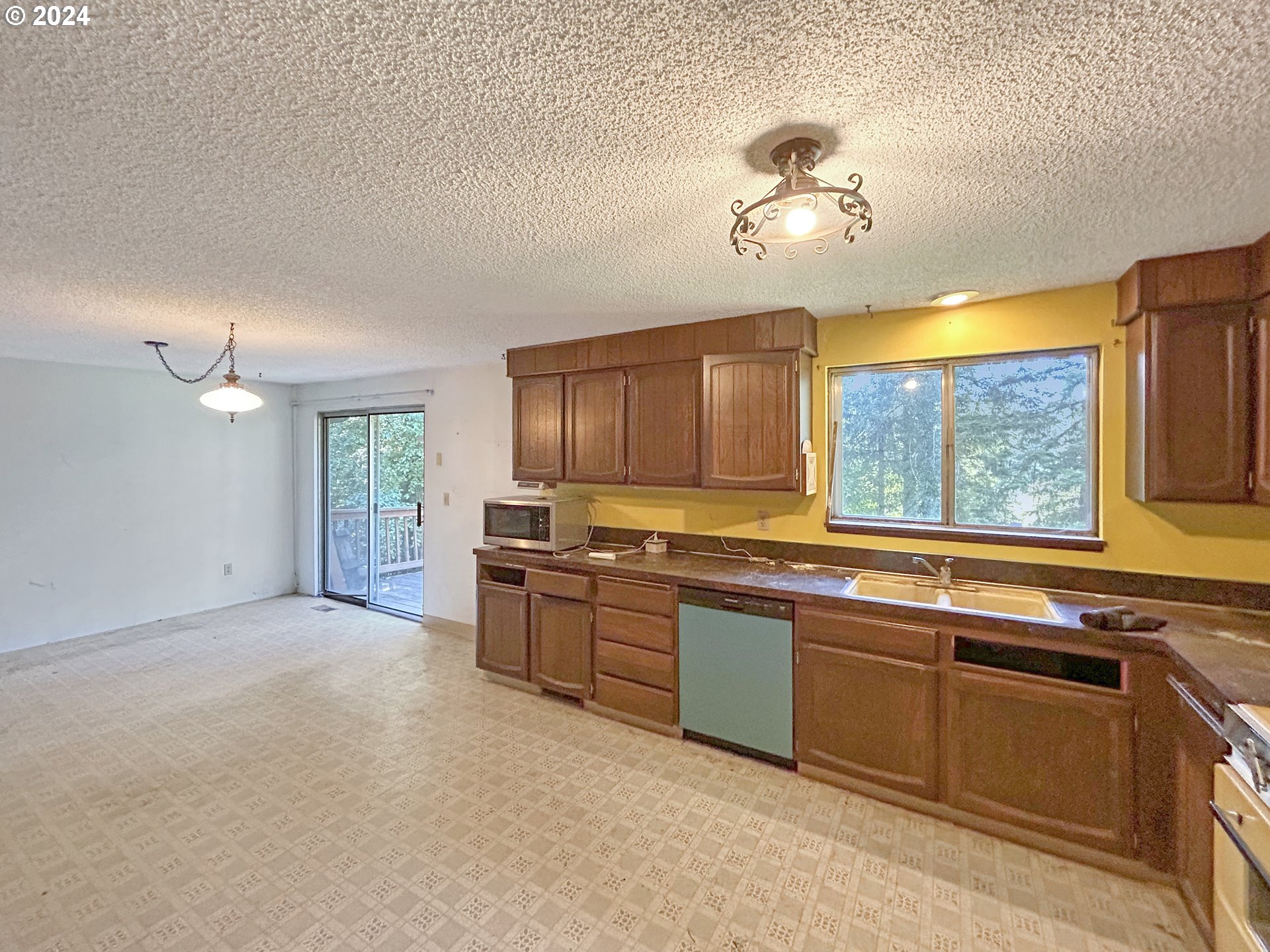 22791 South Reid Road Estacada, OR 97023 - Photo 7 of 21 a large kitchen with stainless steel appliances granite countertop a sink cabinets and a large window