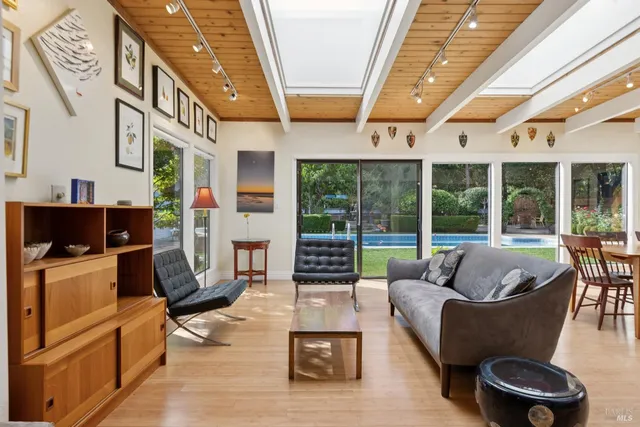 a living room with furniture and large windows