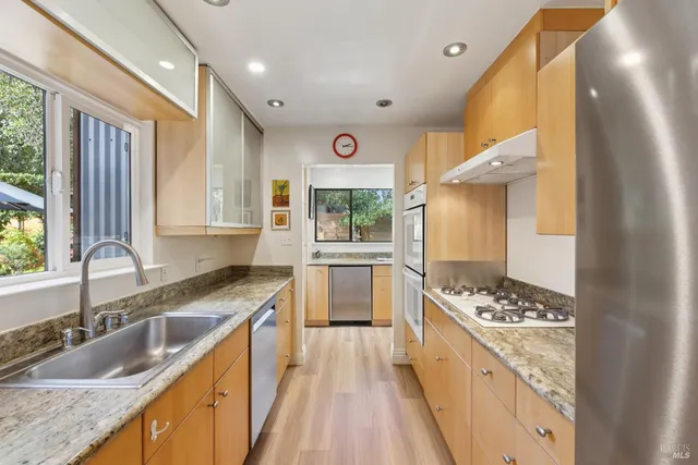a kitchen with a stove a sink and a refrigerator