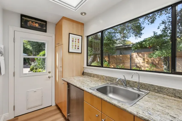 a view of a patio with table and chairs under an umbrella