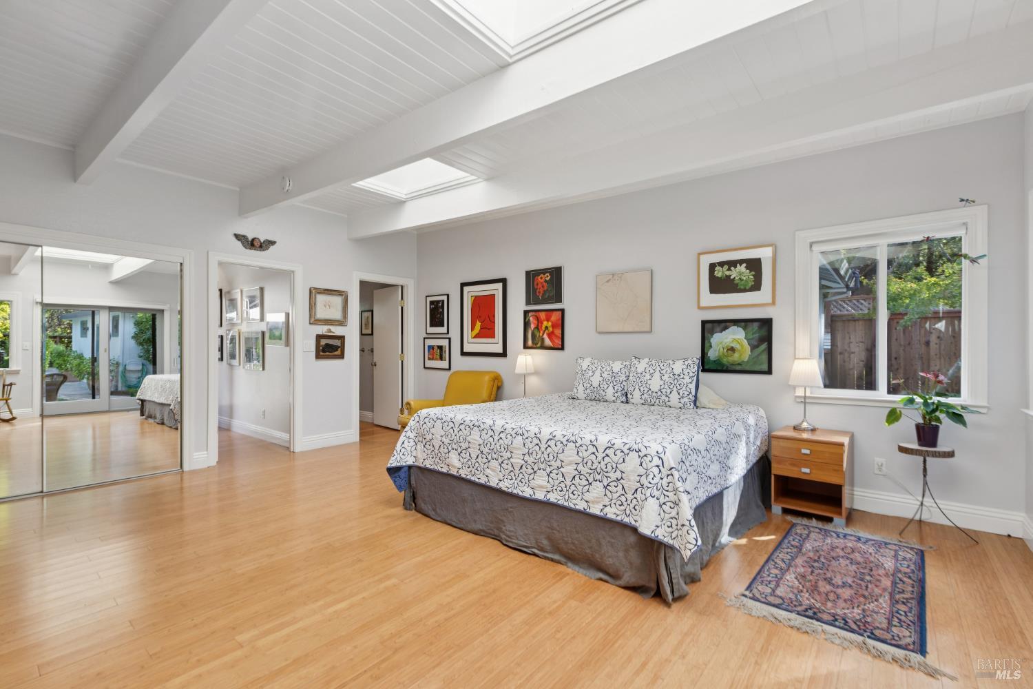 1030 Yell Road Glen Ellen, CA 95442 - Photo 40 of 73 a spacious bedroom with a large bed a rug and windows