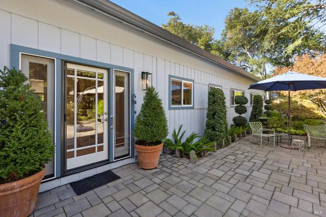 a view of house with backyard and outdoor seating