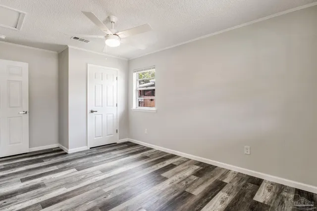 a view of a livingroom with a ceiling fan and window