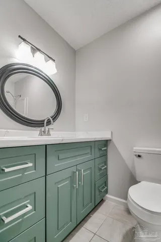 an empty room with a window and ceiling fan