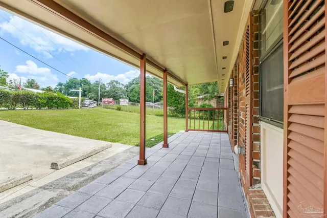 a view of a porch with a table and chairs