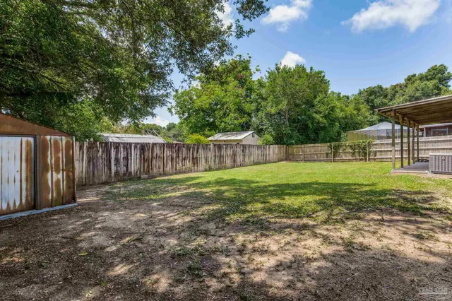 a view of a house with a yard and sitting area