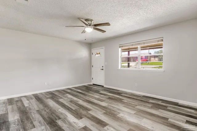 a view of empty room with ceiling fan