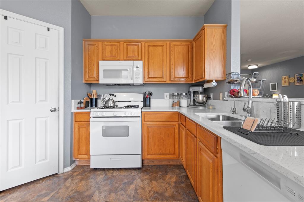 4100 Chisos Rim Trail Fort Worth, TX 76244 - Photo 11 of 30 a kitchen with a sink stove and cabinets