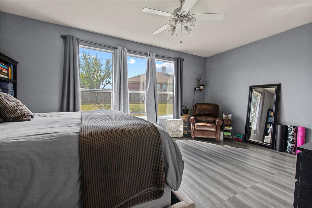 4100 Chisos Rim Trail Fort Worth, TX 76244 - Photo 13 of 30 a bedroom with a bed and wooden floor
